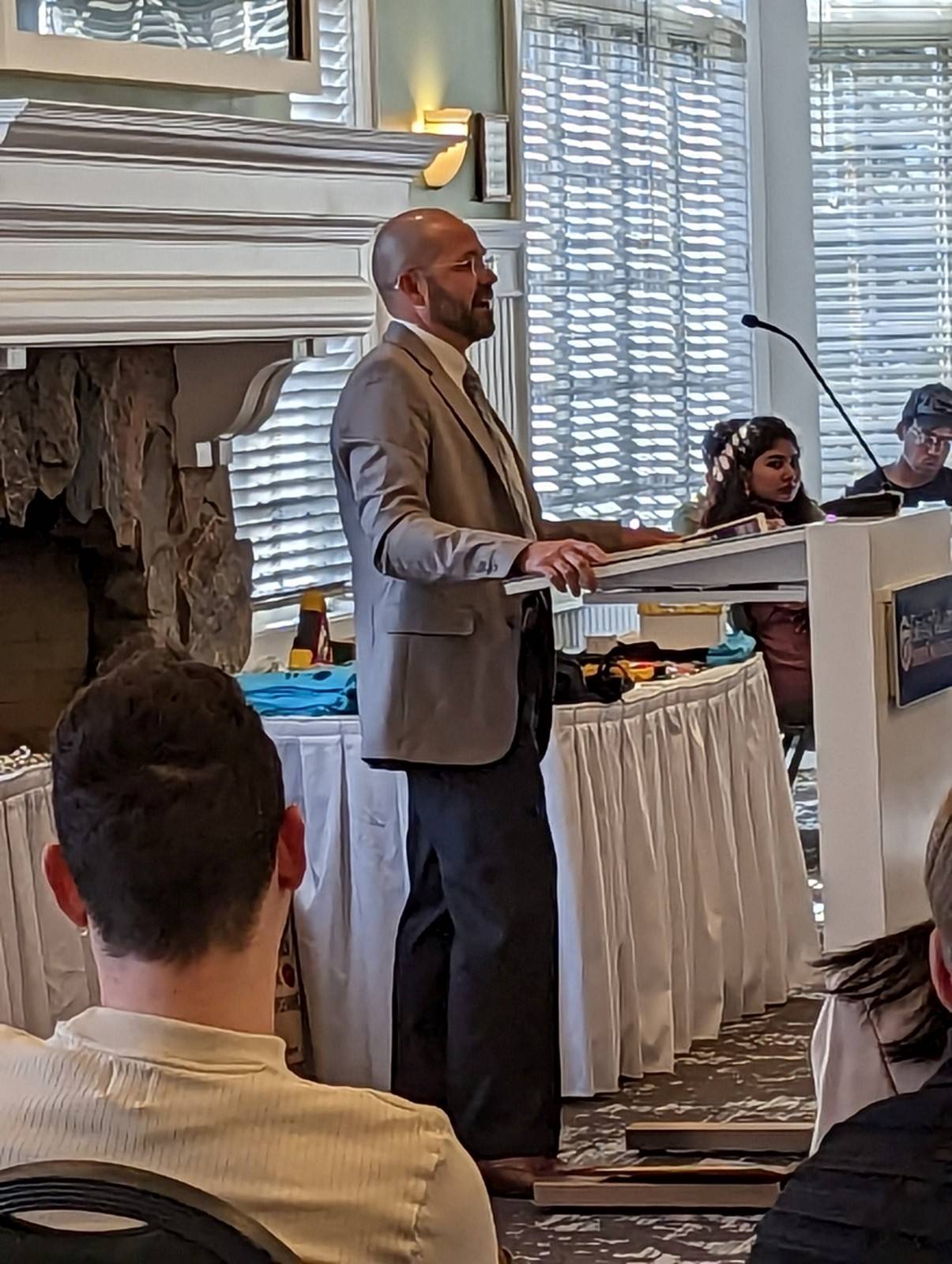 Man standing at podium speaking